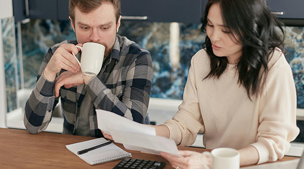Photo - Couple sitting down discussing their home loan