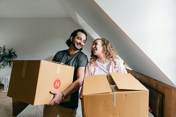 Photo - Young couple moving into their first home